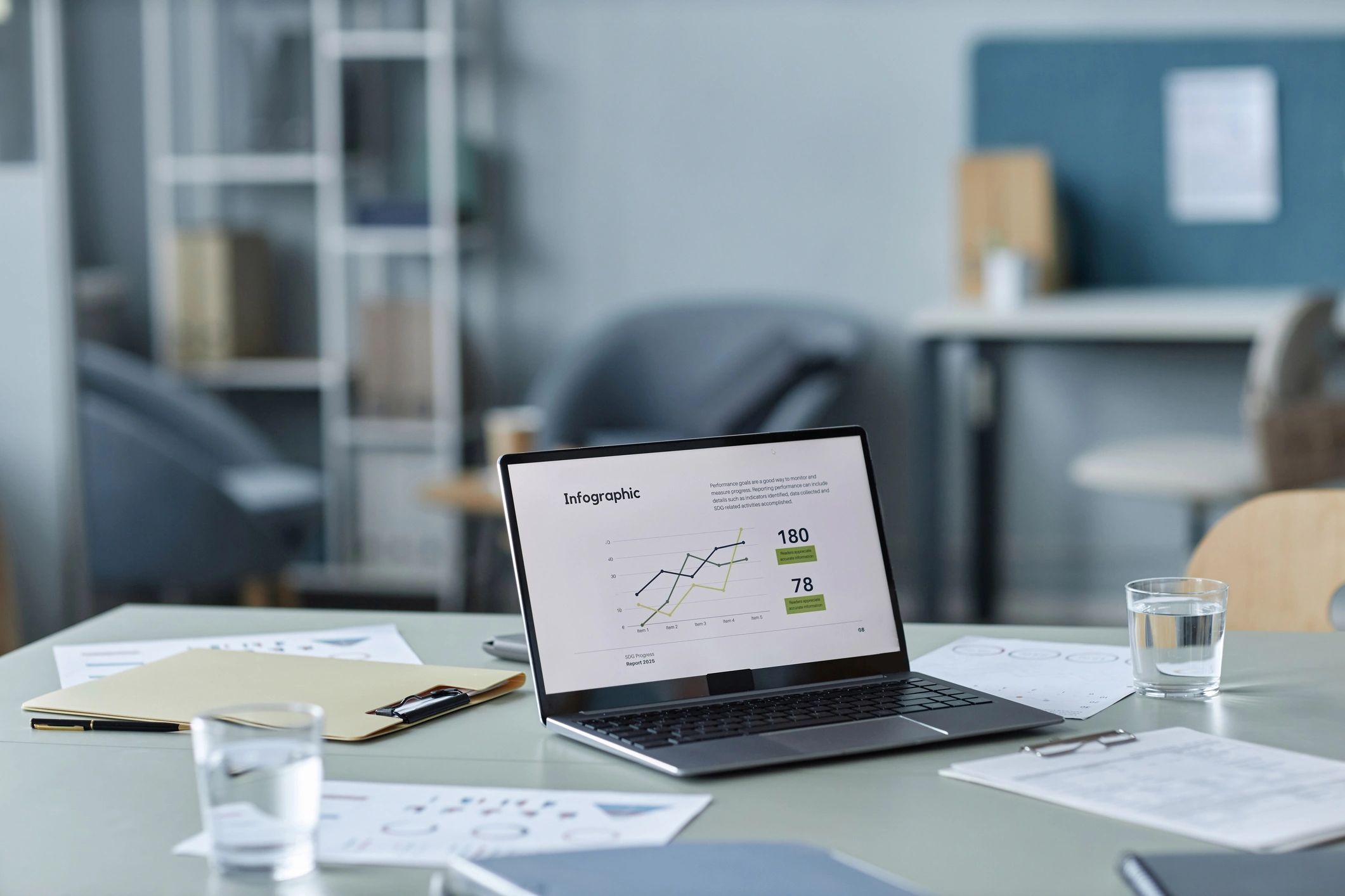 Laptop displaying business charts on a conference table