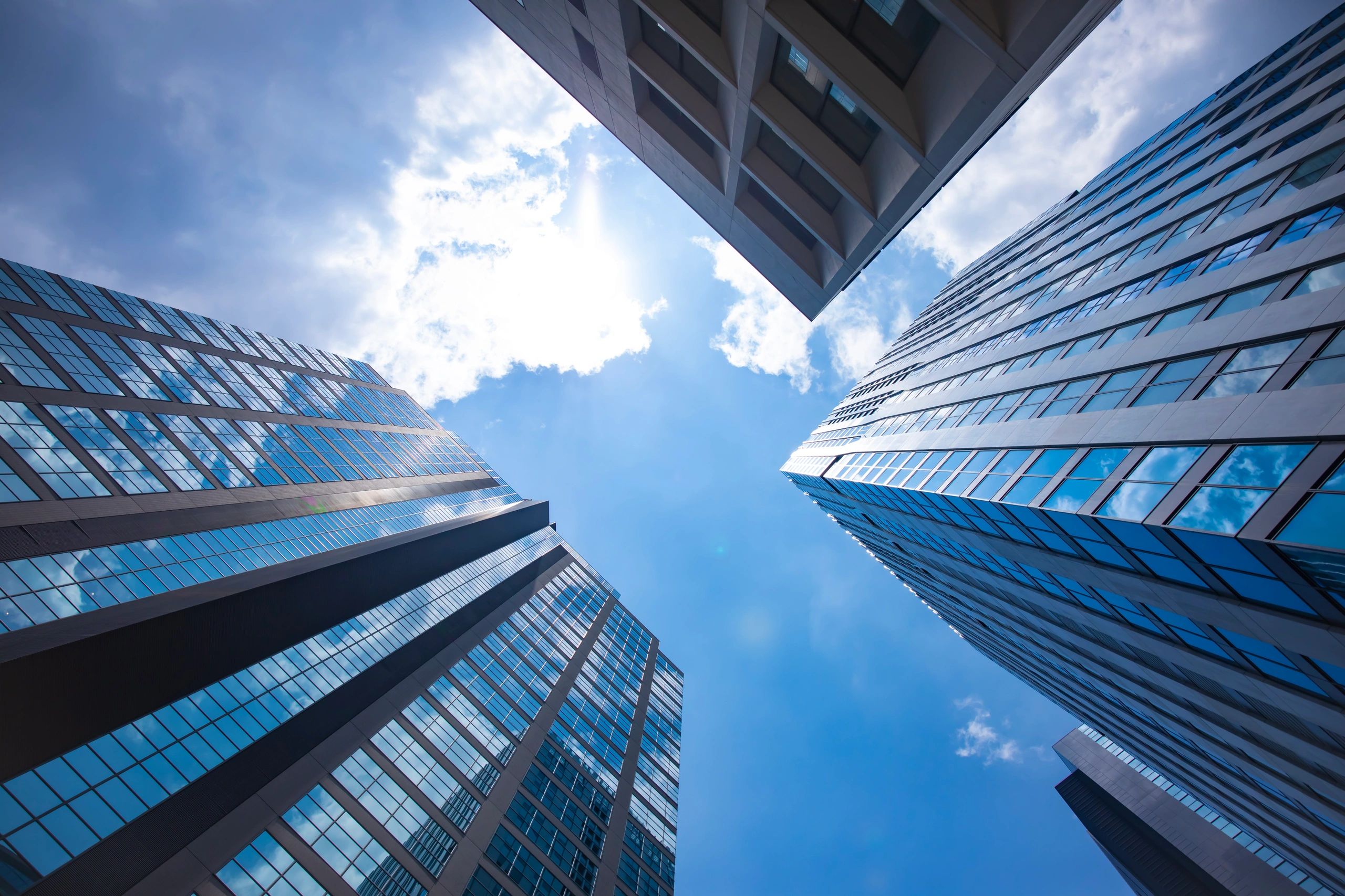 Modern office building exterior reflecting the sky